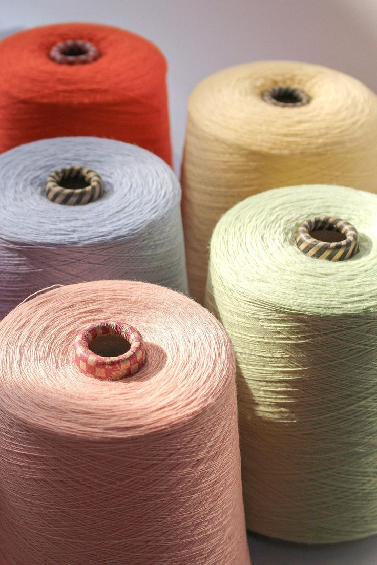 Acrylic yarn cones in coral, cream, grey and pastel shades